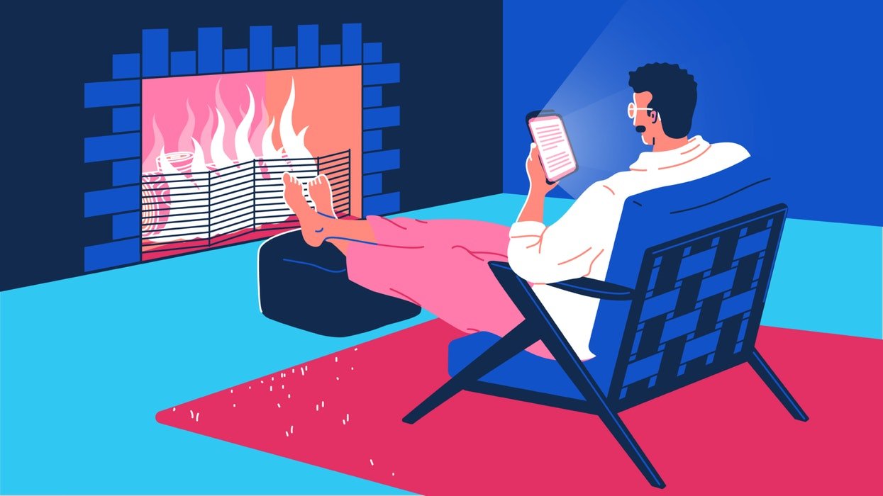 mixkit-man-sitting-in-front-of-a-fire-reading-from-a-66-original-large.jpg